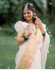 Elegant soft organza Onam Saree with check pattern and zari border. 6.3M length with puff half-sleeve blouse. Machine washable. Includes one gown-style piece.